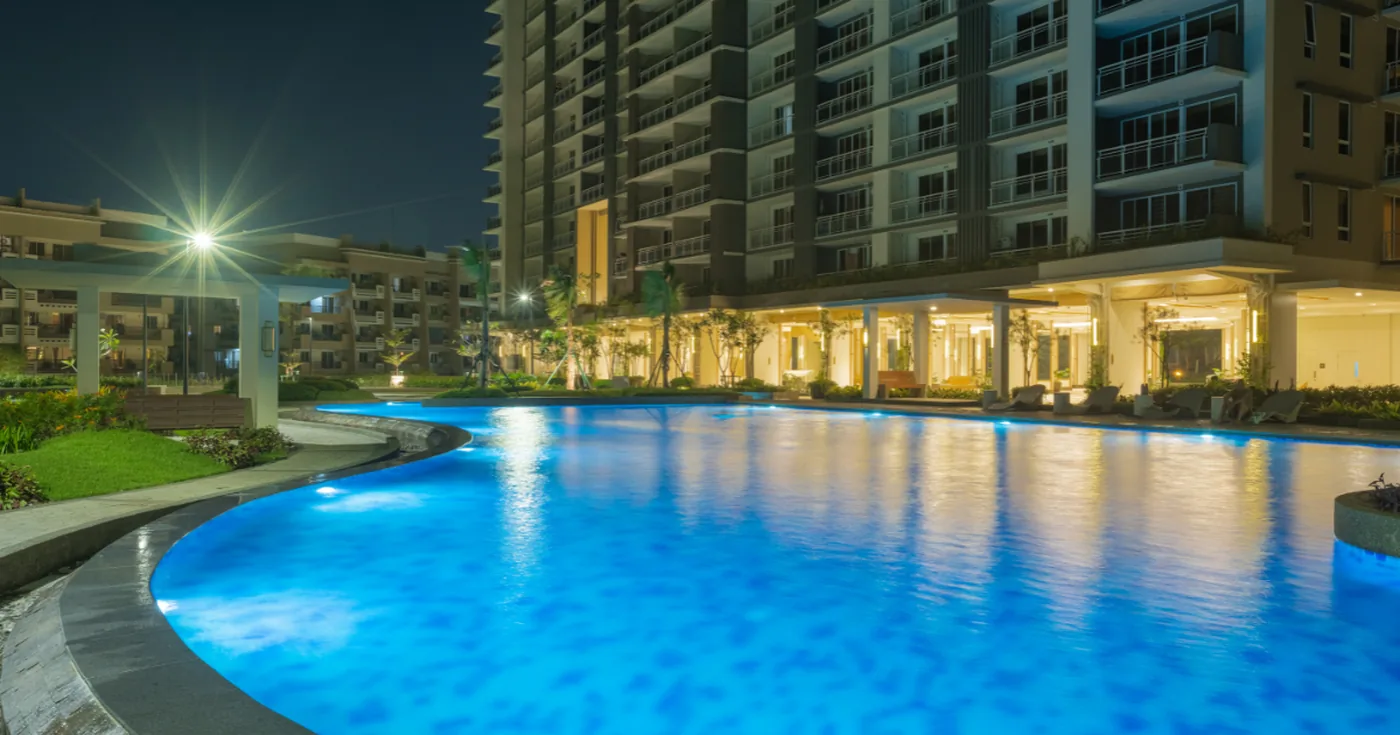 Leisure pool at Alder Residences lit at night