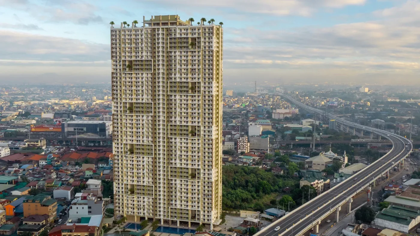 The Celandine tower on A. Bonifacio Avenue, Quezon City, with the elevated highway and the Manila skyline behind it