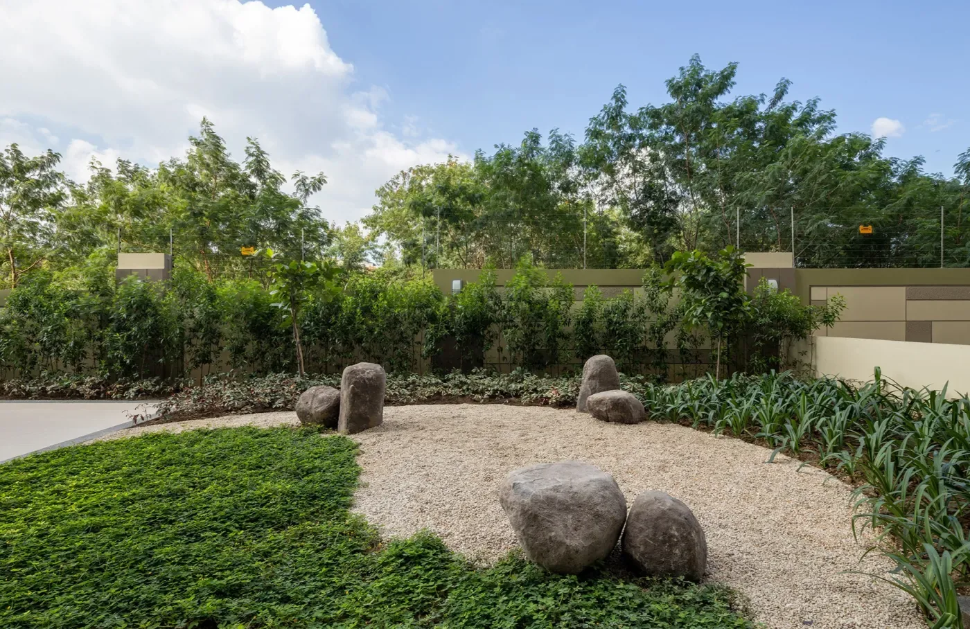 Landscaped garden beds and boulders at The Celandine