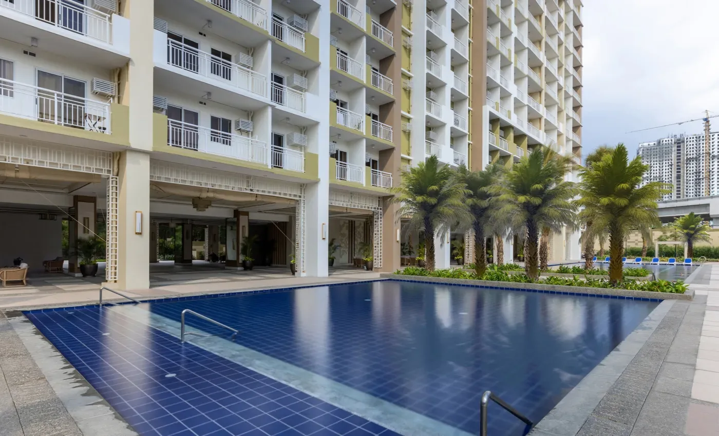 The pool deck at The Celandine with palms and the podium behind
