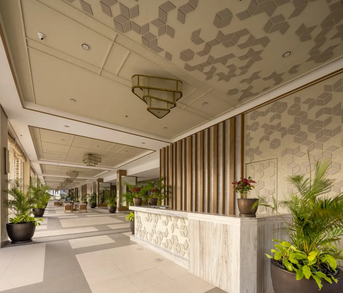 The reception lobby at The Celandine with a patterned ceiling and a long reception counter