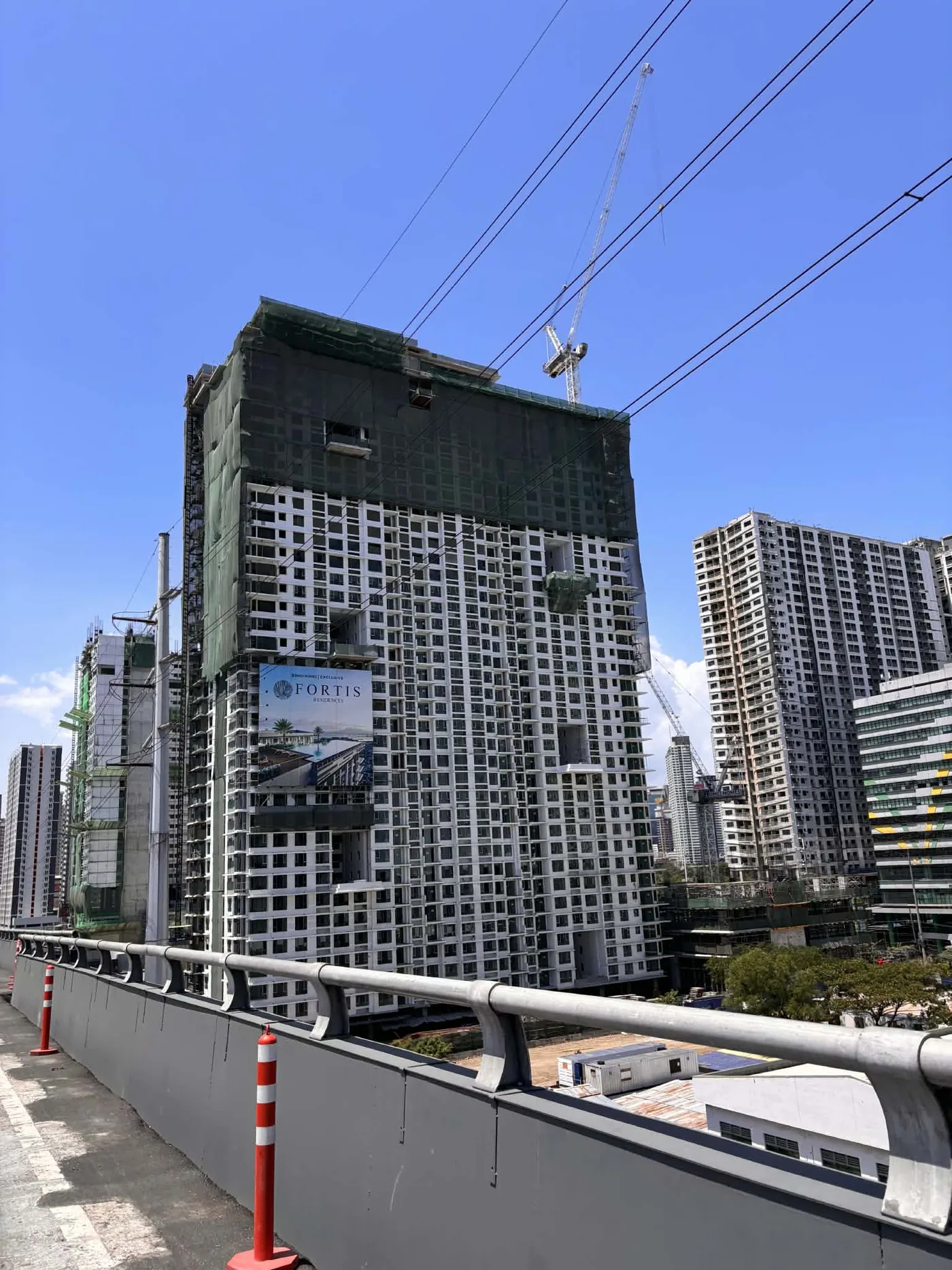 Fortis Residences tower from street level, April 2026, Chino Roces Avenue Makati