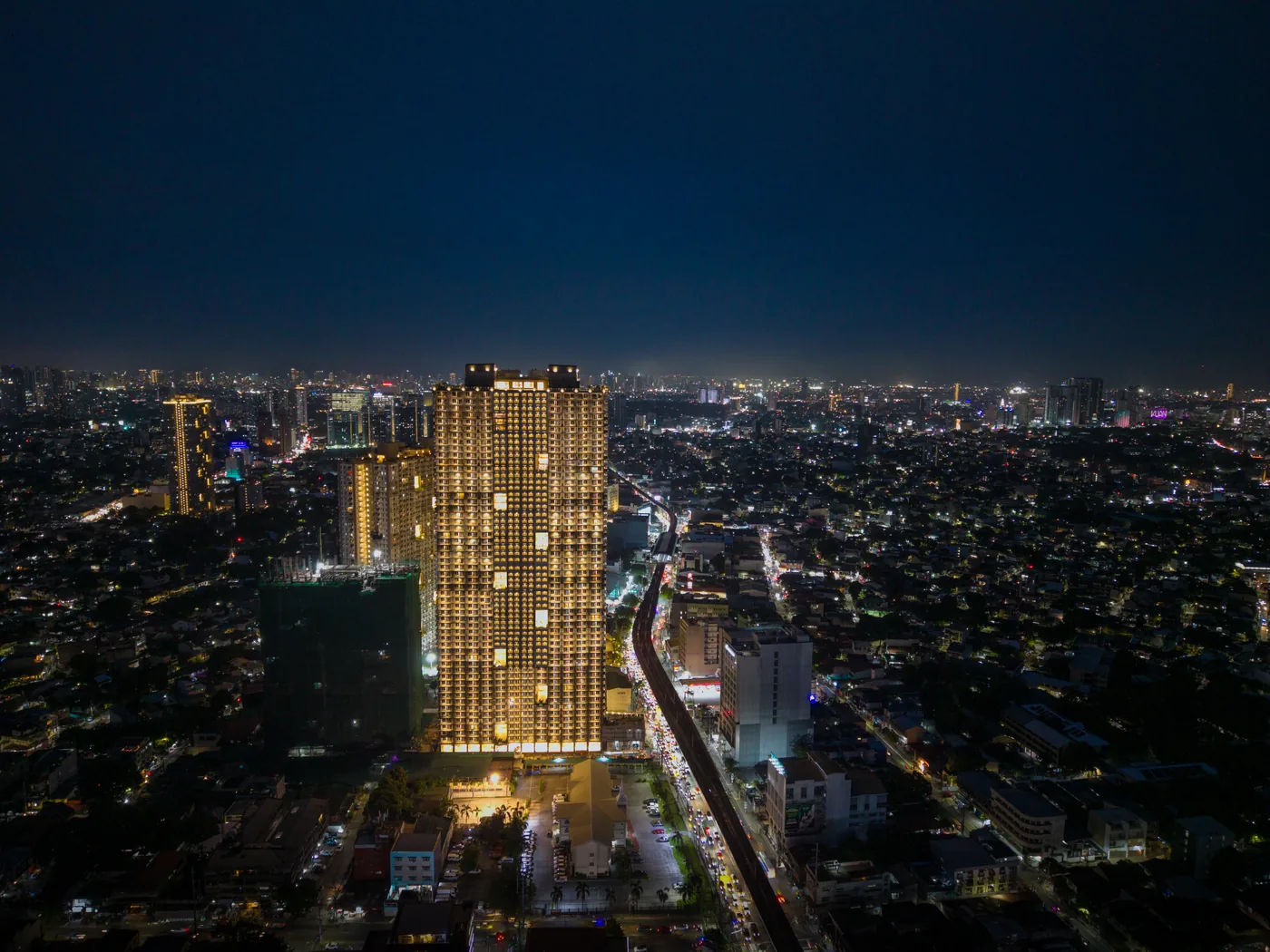 The Oriana North Tower glowing over Quezon City at night