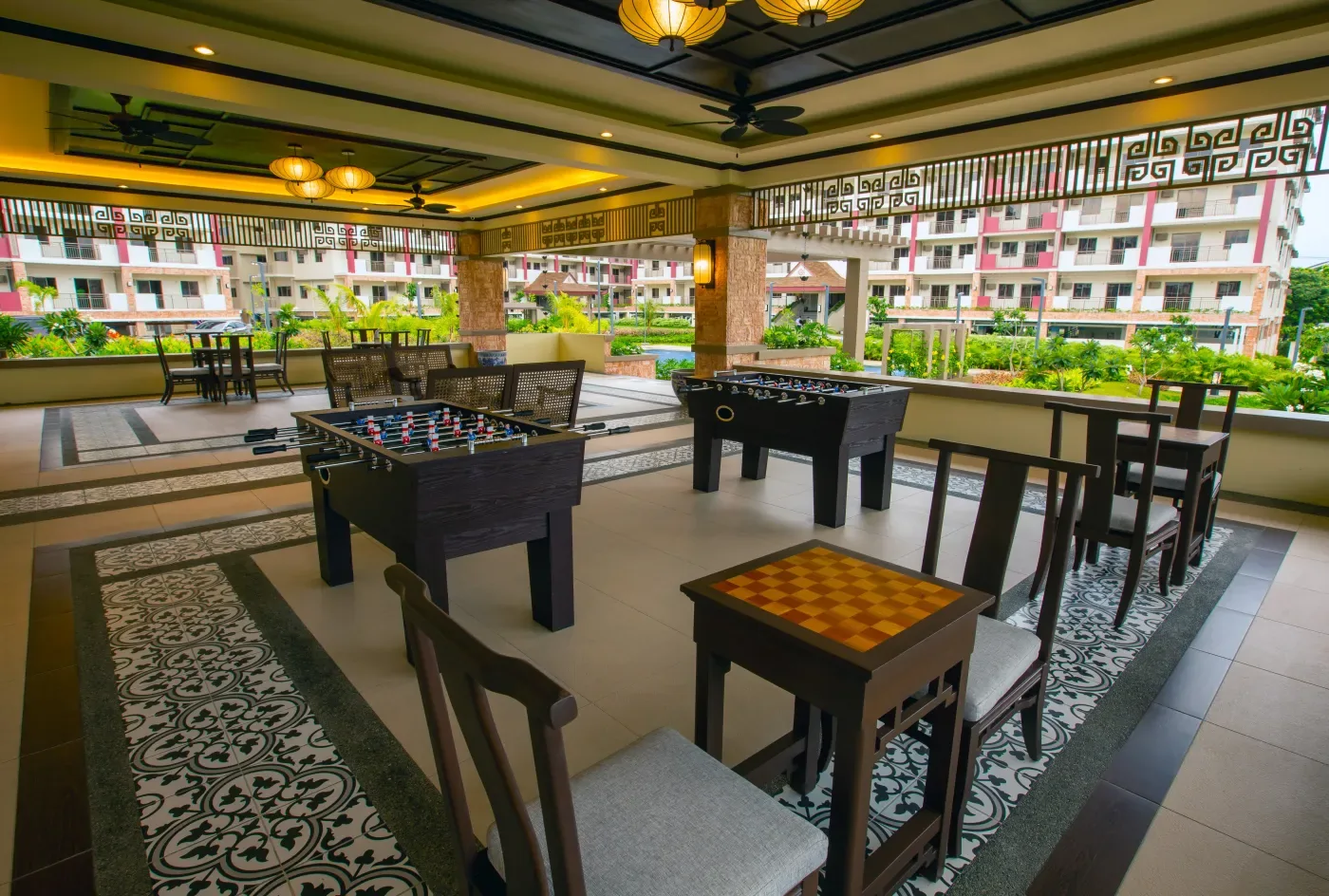 Open-air game room at Mulberry Place with foosball and games tables