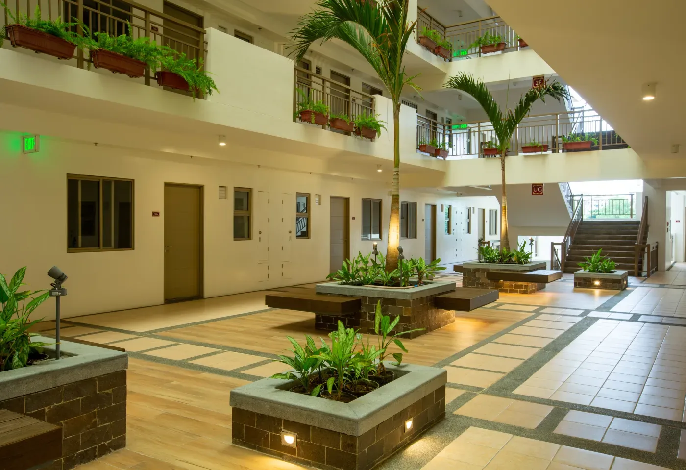 Landscaped atrium inside a Mulberry Place building with planters and palms