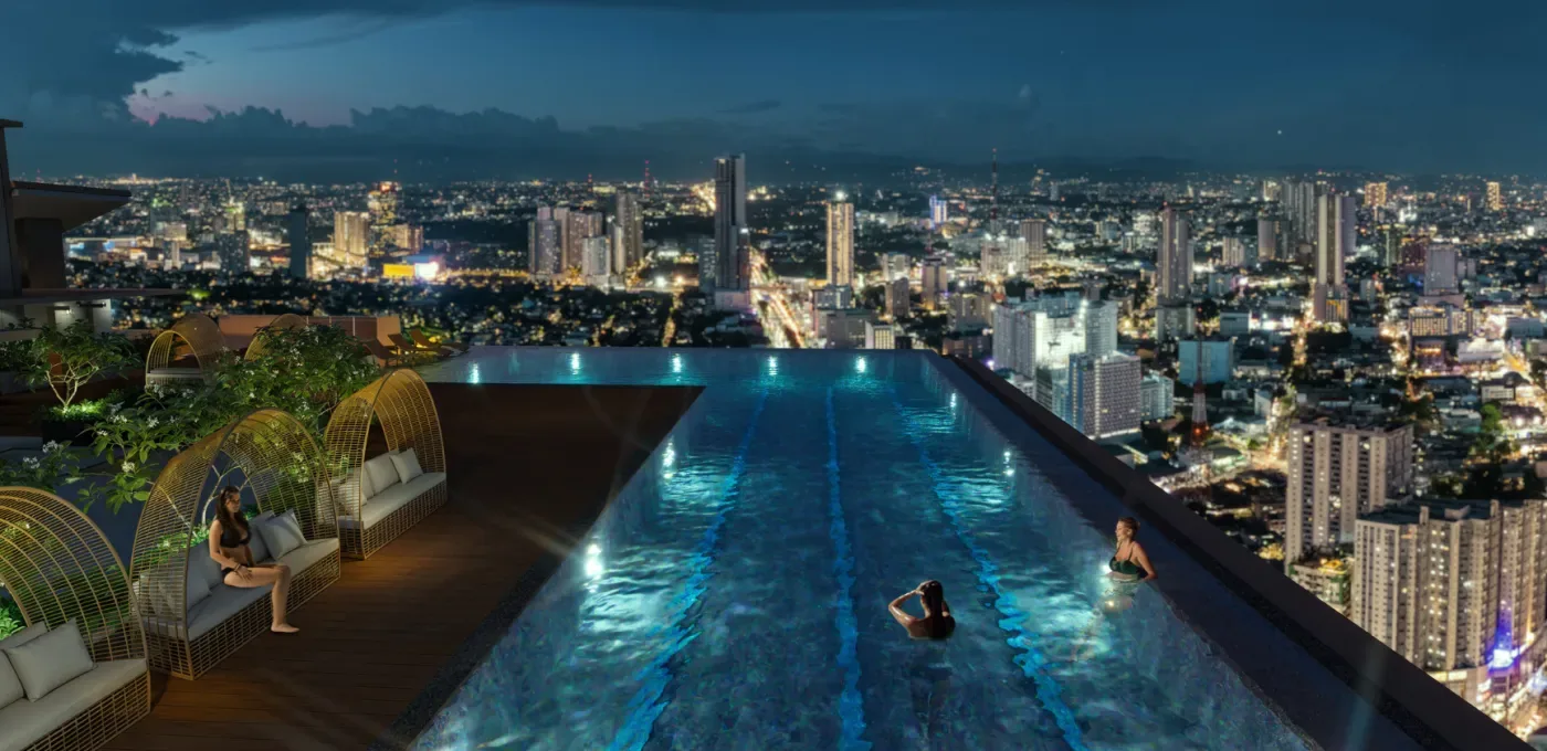 Sky deck infinity pool at One Delta Terraces at night, overlooking the Quezon City skyline