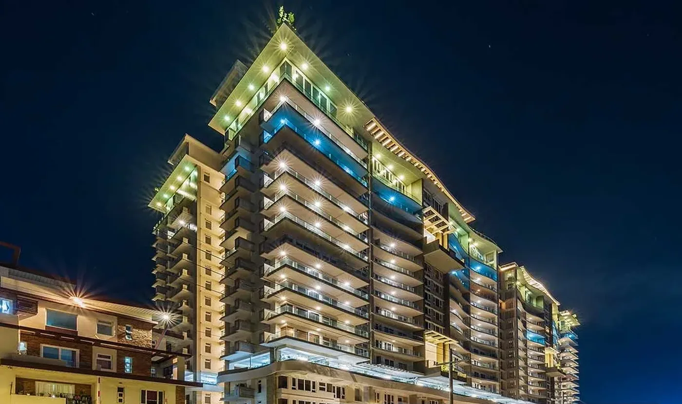 Oak Harbor Residences building facade lit at night
