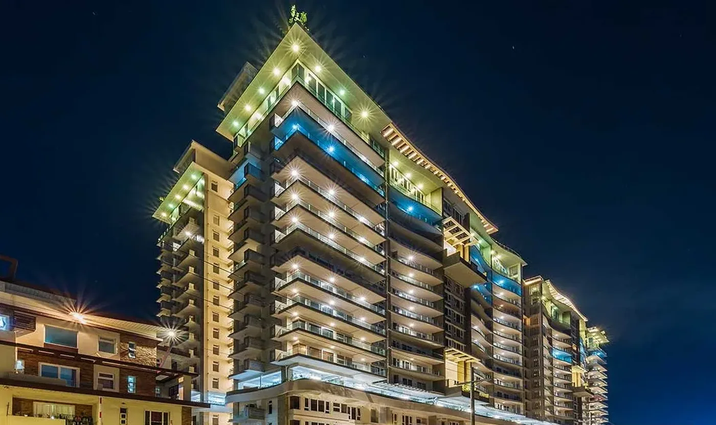 Oak Harbor Residences building facade at dusk, Jackson Avenue, Parañaque