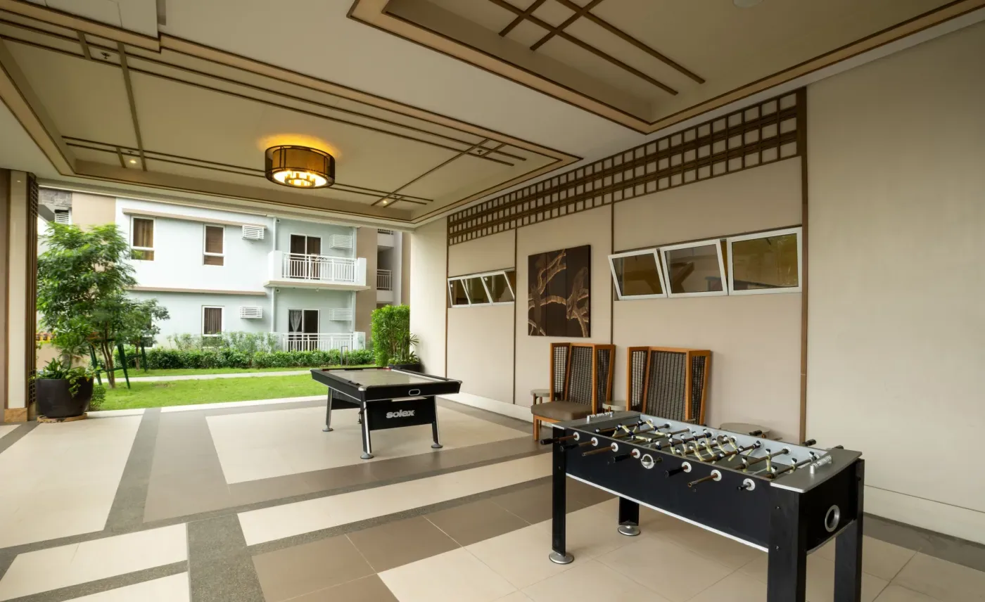 Indoor game area with foosball tables at Satori Residences
